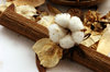 cotton flower abstract: cotton flowers with  rattan tablemat and wooden bowl,dry flower and lefas around