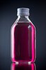 Cough Medicine: A pink/red cough medicine on a gray/black background.