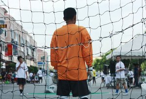The Goalkeeper: Snapshot of a goalkeeper at a street futsal game