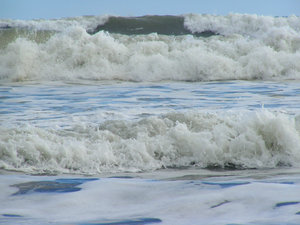 small waves breaking: New Zealand beach foam