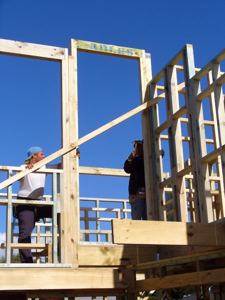 House framing with builders: Couple of builders on house frame. 