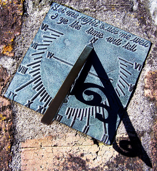 sundial: Sundial face on rough brick.   sorry for the angle, but trying to get the shadow in the pic.