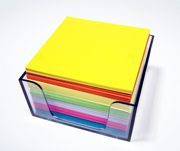 Take a message...: Memo cube of coloured paper squares in the office.