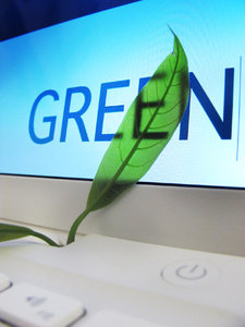 green computing: laptop screen detail with green leaf & text 