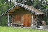 Alpine log cabin: A log cabin in the Alps.
