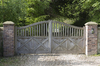 Driveway gates: Ornamental oak gates to the driveway of a rural estate in West Sussex, England.