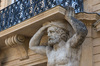 Balcony statue: An old statue supporting a balcony in Aix en Provence, France.
