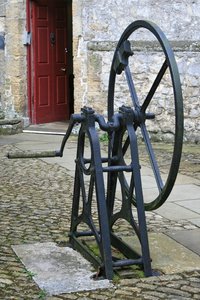 Old hand pump: An old hand pump in the courtyard of a manor house in England.