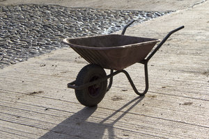 Farmyard wheelbarrow: A wheelbarrow in a farmyard in northern England.
