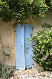 Old blue shutters: Old blue door shutters on a house in the Dordogne, France.