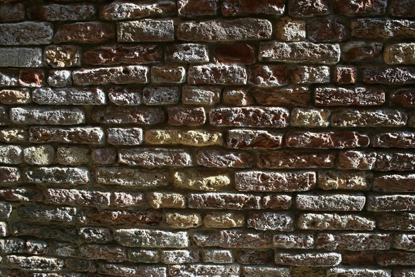 Old bricks in oblique light: An old brick wall in Venice, lit by very oblique light.