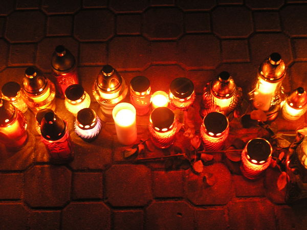 Candles: Some candles on the pavement.