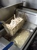 French Fries Cooking: A basket of French Fries cooking in a deep fryer