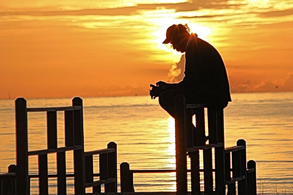 Silence: A man praying at sunrise