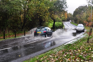 Floods: Flooded road, in Autumn, still raining.