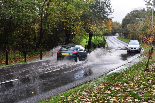 Floods: Flooded road, in Autumn, still raining.