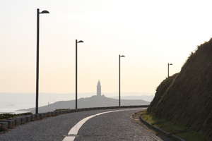 On the road: On the road in A Coruña. The oldest lighthouse working in the world as background.
