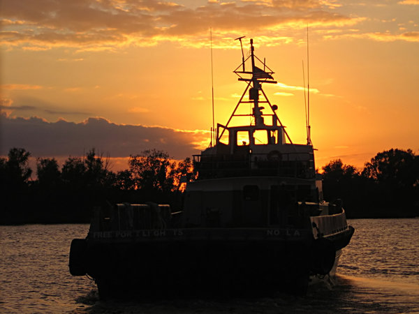 Night Run: Boat leaving at sunset.