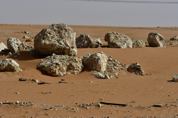 Rocks found in the desert: Desert landscape in red sand and some rocks found . This is in the heart of Saudi Arabian desert.