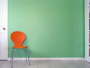 Green Wall 1: Orange chair in front of a green wall.