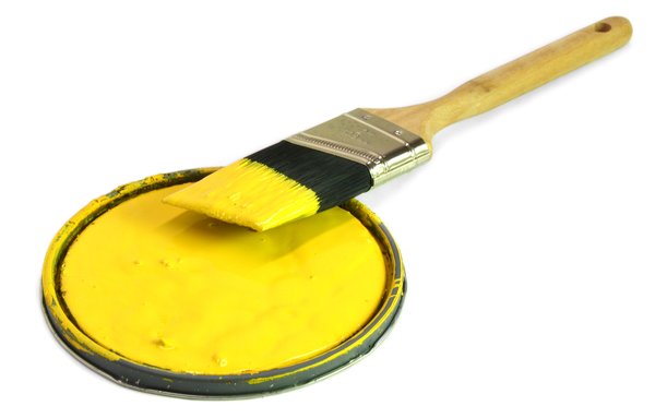Painting 3: Paint brush resting on a can lid, isolated on white background.