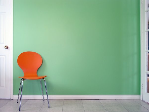 Green Wall 1: Orange chair in front of a green wall.