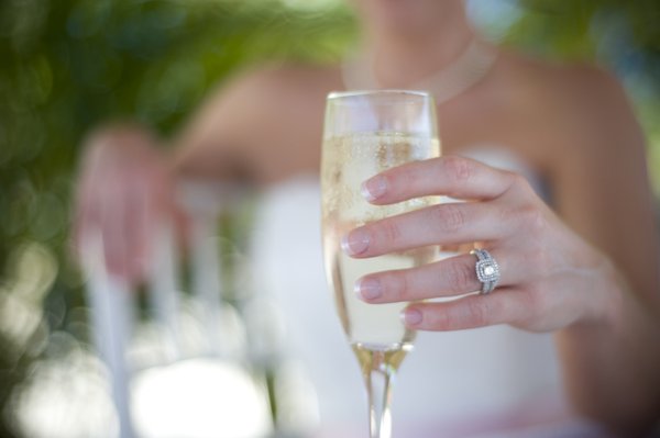 Champagne: Holding a glass of champagne.