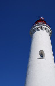 Summer Lighthouse: Lighthouse tower against a clear blue summer sky