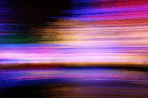 Streaks of Light: Abstract background generated from camera panning on Christmas lights.