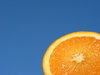 Orange and Blue 1: Natural high contrast - crisp and fresh orange with blue sky background. Put the orange on a metal stick and held it up against the evening sky slightly tilted towards the sunlight.