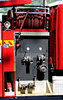 fire & rescue action: fire and rescue team and vehicles attending suburban house fire