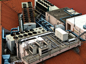 rooftop aircons: looking down on a number and variety of rooftop air conditioning units