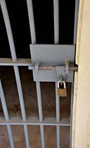 locked in: locked and barred cell door