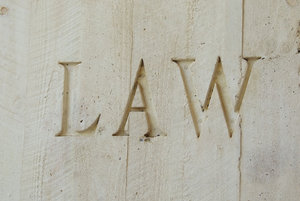 set in concrete: the word 'LAW' engraved/set in concrete