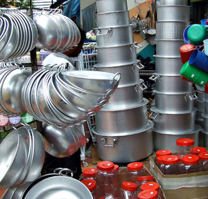 pots and pans: variety of pots, pans, containers, on display and for sale