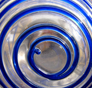 spiralling in blue: dusty outdoors glass garden ornament with blue spirals