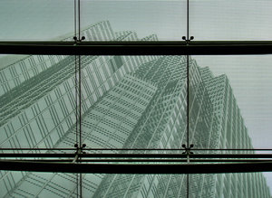 wired-up windows: modern glass and steel building frontage showing high-rise office complexes on the other side of the windows
