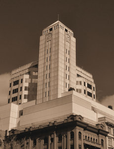 art deco clock tower4: large city art deco commerical business complex tower clock  - in sepia