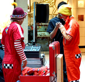 clowning around1: clowns preparing for their act in a multicultural shopping mall