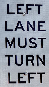 reflective left turn sign: reflective left turn vehicular traffic sign - only one way to go