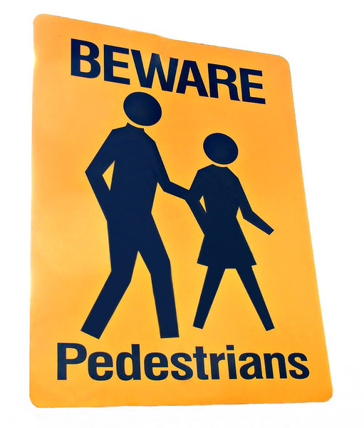 dangerous pedestrians: black on yellow street sign warning of pedestrians crossing road