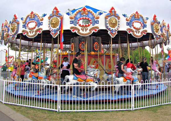 on the roundabout: a carnival's children's horse carousel - merry-go-round