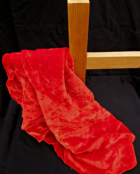 cross & crown of thorns: red cloth draped wooden cross and black background