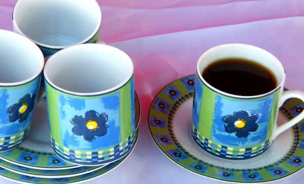 black coffee for one: coffee cups and saucers with one cup of black coffee