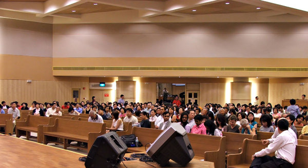 meeting readiness: members of church congregation ready for meeting to start in Singapore church