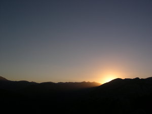 peeking through: sunset over mountains spain