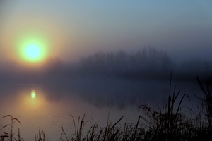 Sunrise in Texas: Faint light at dawn on large pond in Texas
