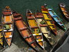 Rainbow Boats: Colourful rowing boats parked at Lake Sat Taal in Uttarakhand, India.