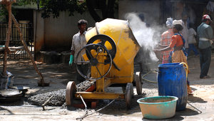Cemented 1: This yellow machine you see is a primitive rotating drum like contraption that acts as a mixer to make cement. Water, jelly stones, cement and sand is thrown in to form cement. Of course you see more sophisticated and automatd versions of the cement maker
