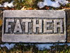 Father: Grave marker in an ancient cemetary across from a hill where lots of people were sliding on the snow in Kentville, Nova Scotia, Canada.